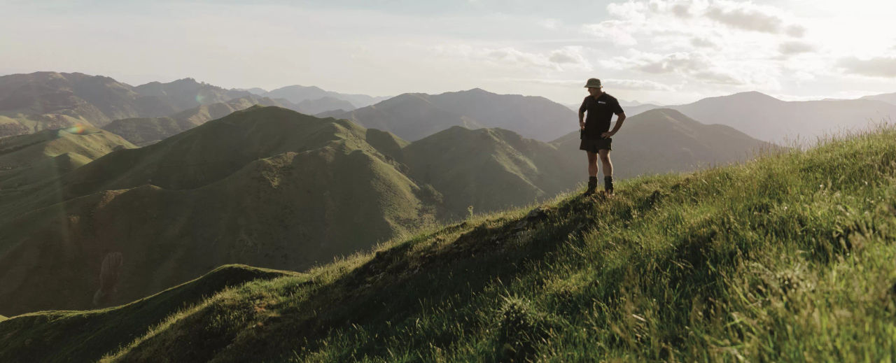 Farmer standing on top of a hill